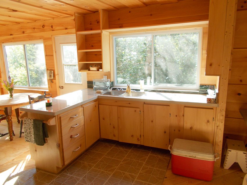 L-shaped kitchen with double sink looking out a large window